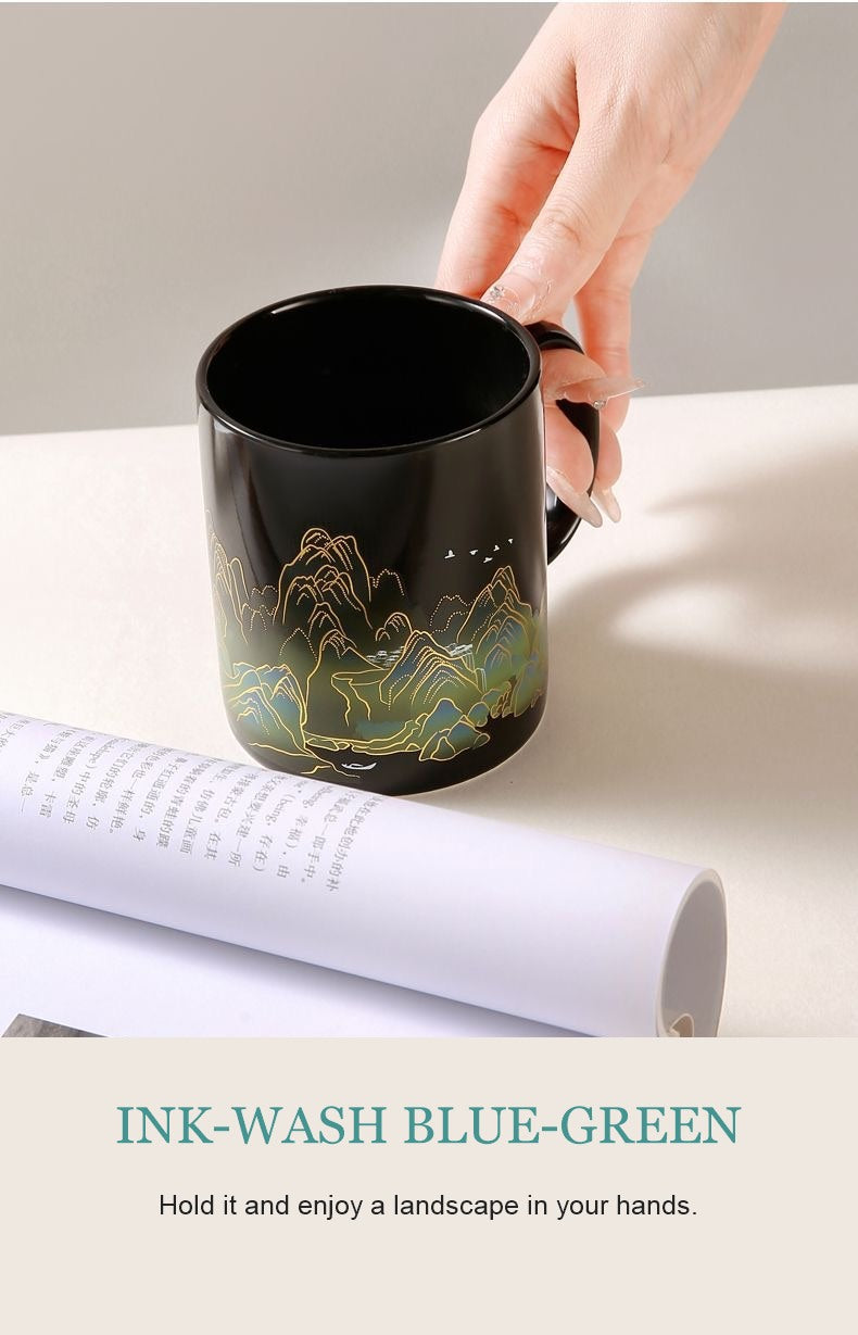 Ink-wash blue-green glossy mug held in hand