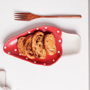 Red mushroom ceramic leaf plate with bread slices