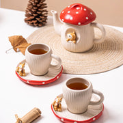 Red mushroom ceramic tea table scene with teapot and cup saucer