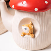 Red mushroom ceramic squirrel relief detail on teapot