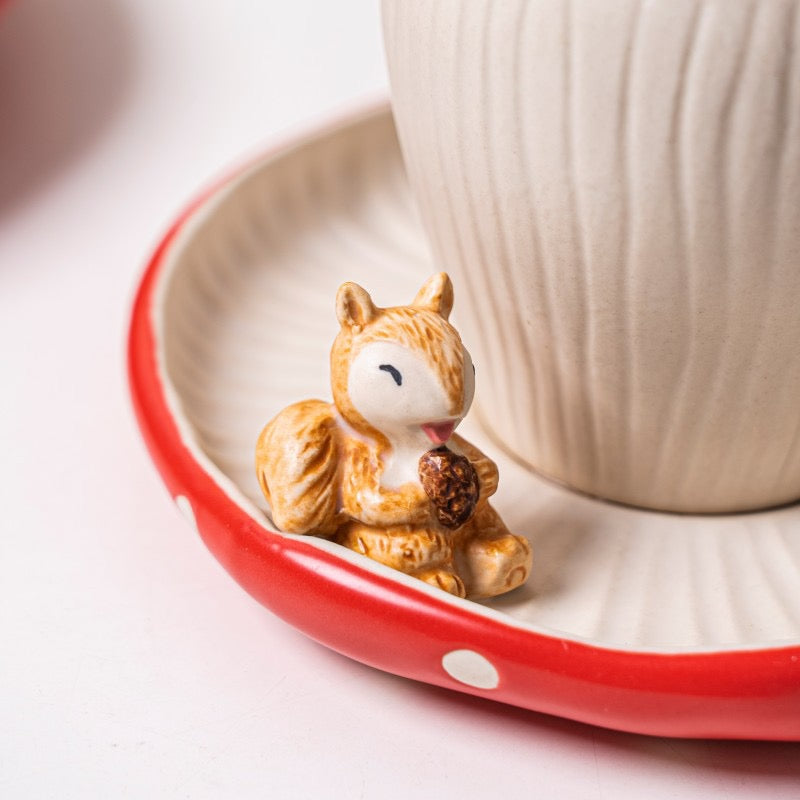 Red mushroom ceramic cup and saucer squirrel detail closeup